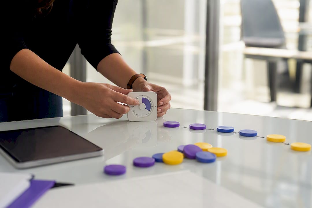 Hands adjusting timer next to workflow tokens