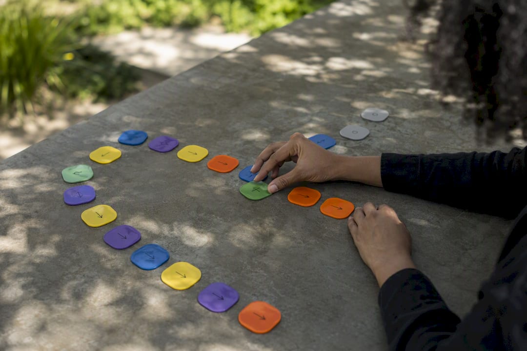 Hands arranging workflow tokens on table