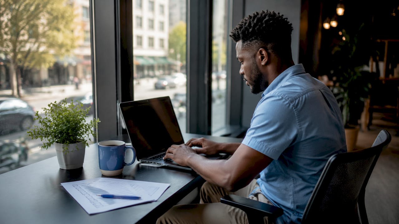 Hands typing product feed data in office