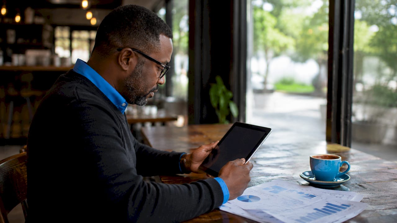 Close-up of SEO specialist reviewing data on tablet