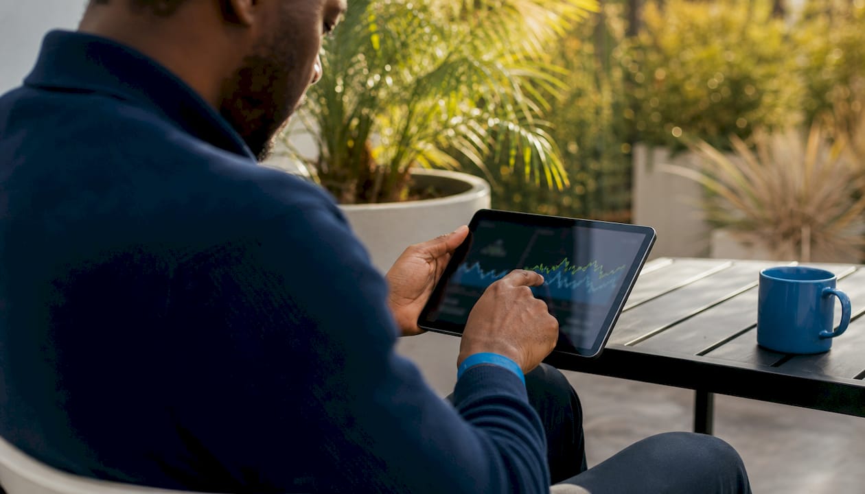 Hands adjusting SEO tool data settings on tablet