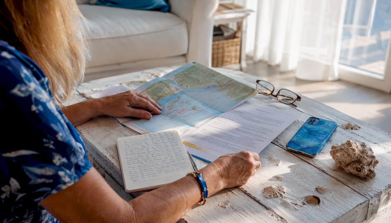Hands reviewing vacation rental documents on table