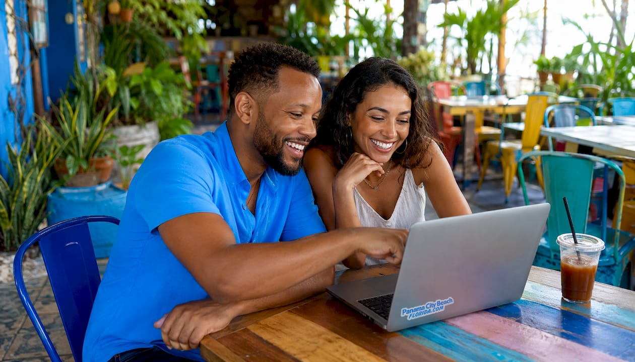 Couple browsing rental listings on laptop