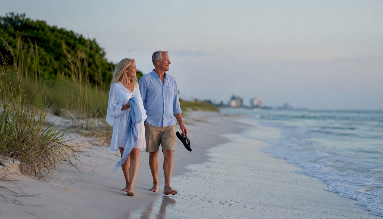 Couple walking along calm Gulf Shores beach