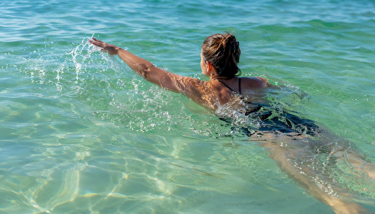 Swimmer entering warm Gulf water at Panama City Beach
