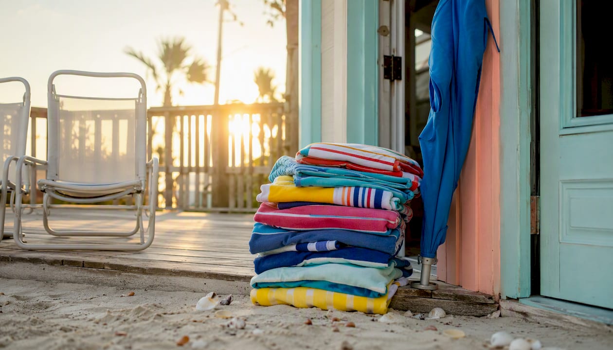 Beach towels and gear on rental porch