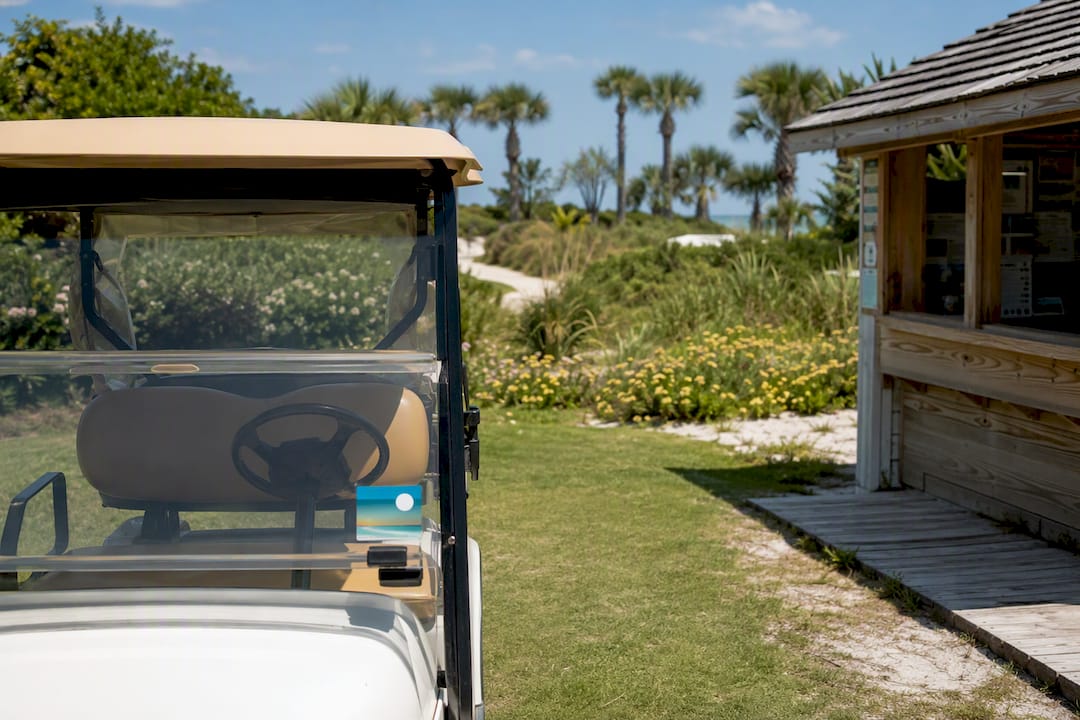 Golf cart parked near parking permit kiosk