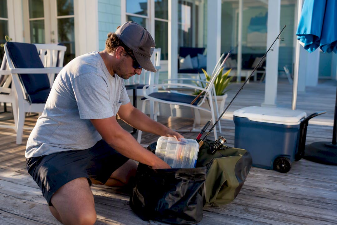 Hands packing fishing gear in bags