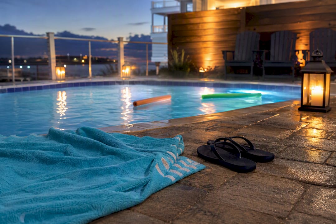 Pool entry items by heated pool at dusk