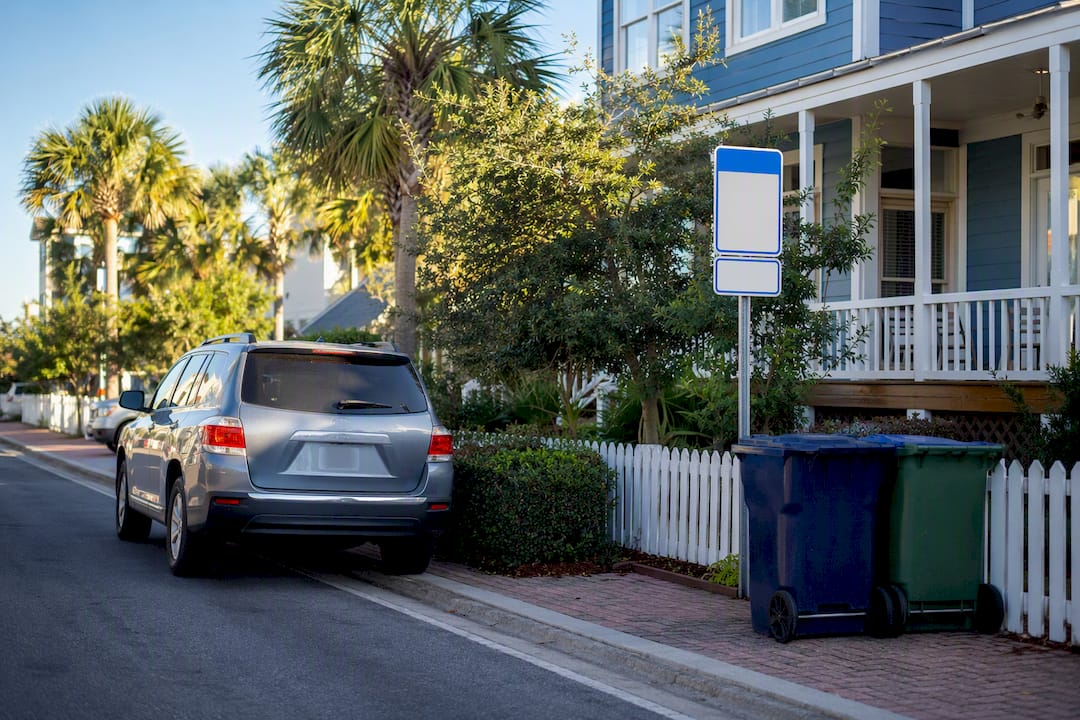 Vacation rental exterior with parking and noise signage