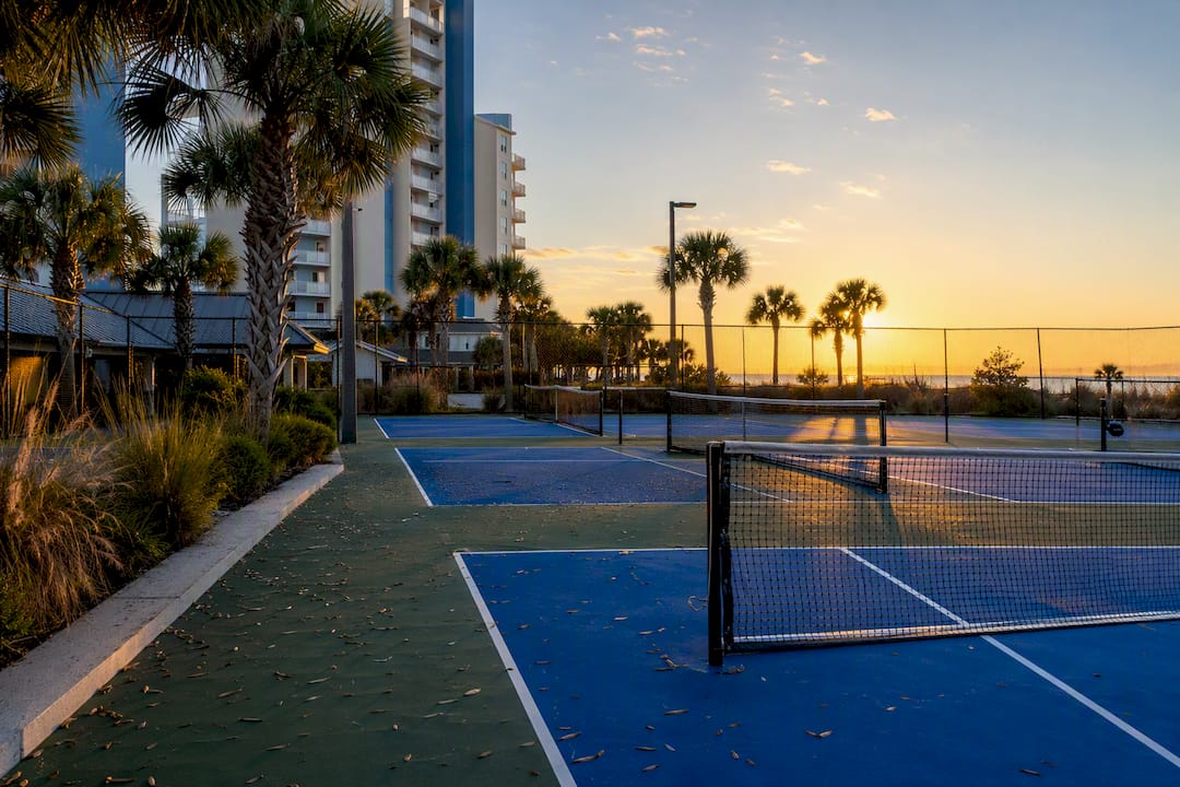 Empty tennis and pickleball courts at coastal resort