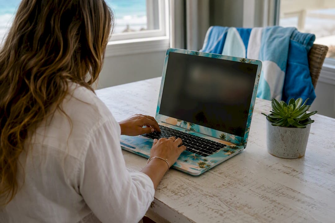 Hands on keyboard selecting vacation rental photos on laptop