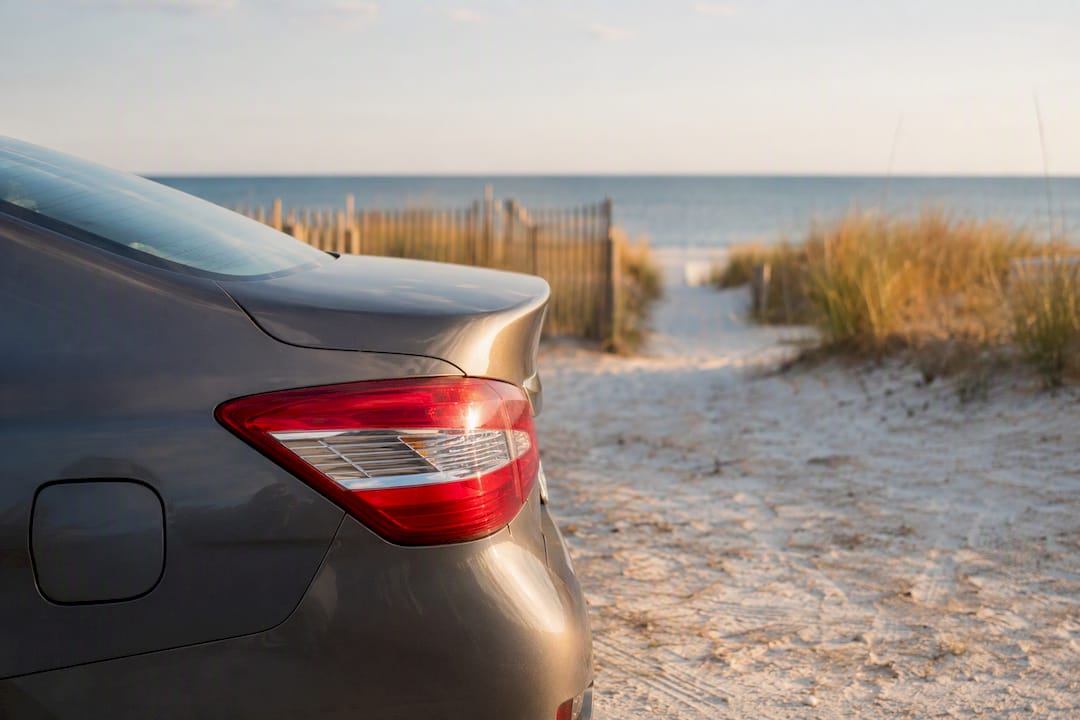 Rental car parked near beach dunes