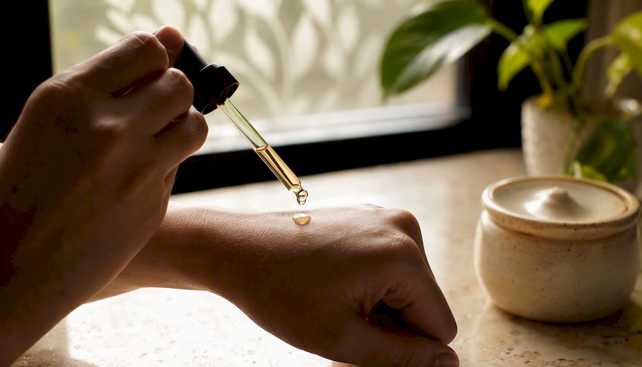 Applying retinoid serum with dropper