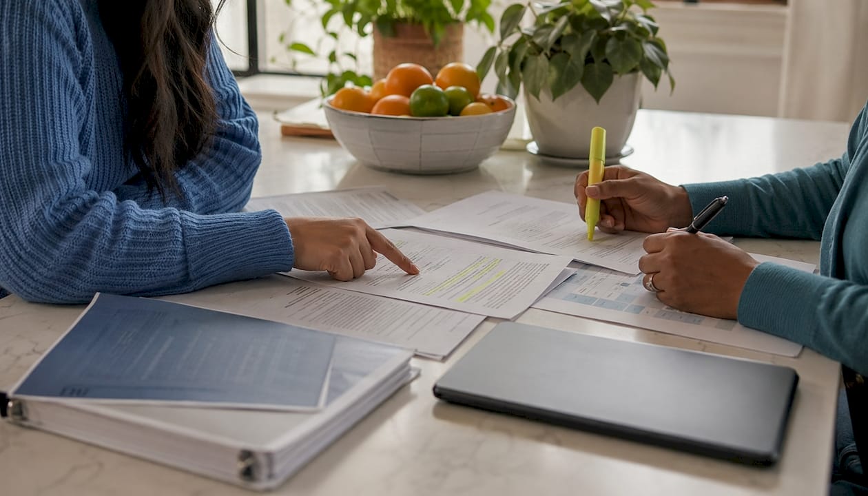 Hands reviewing BCBA district role documents