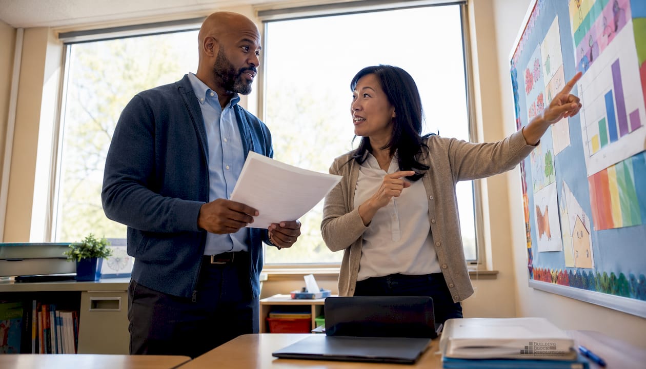 Two teachers discussing autism inclusion strategies