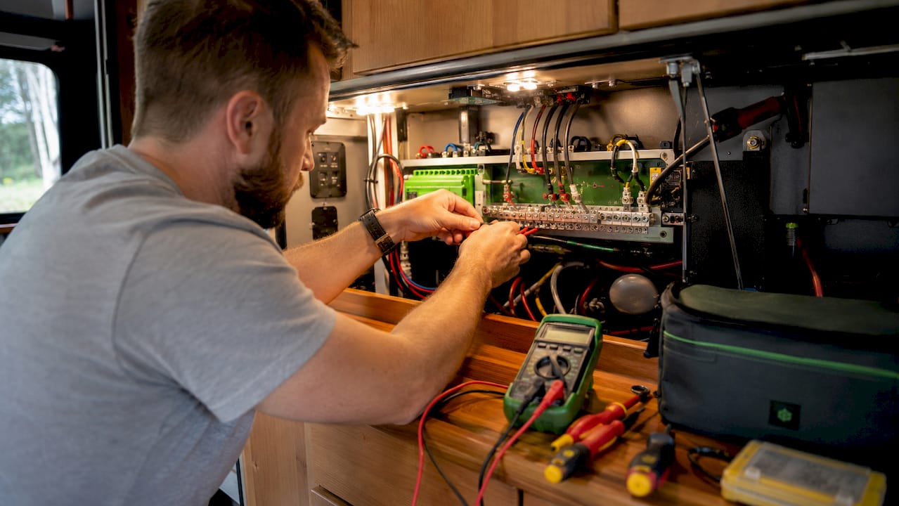 Technician wiring RV solar power control panel