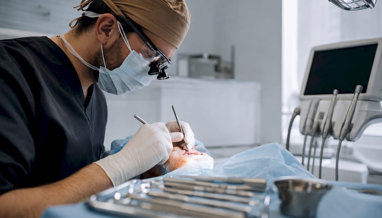Dental surgeon performing implant access surgery