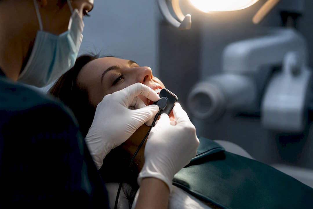Dental clinician positioning digital X-ray sensor
