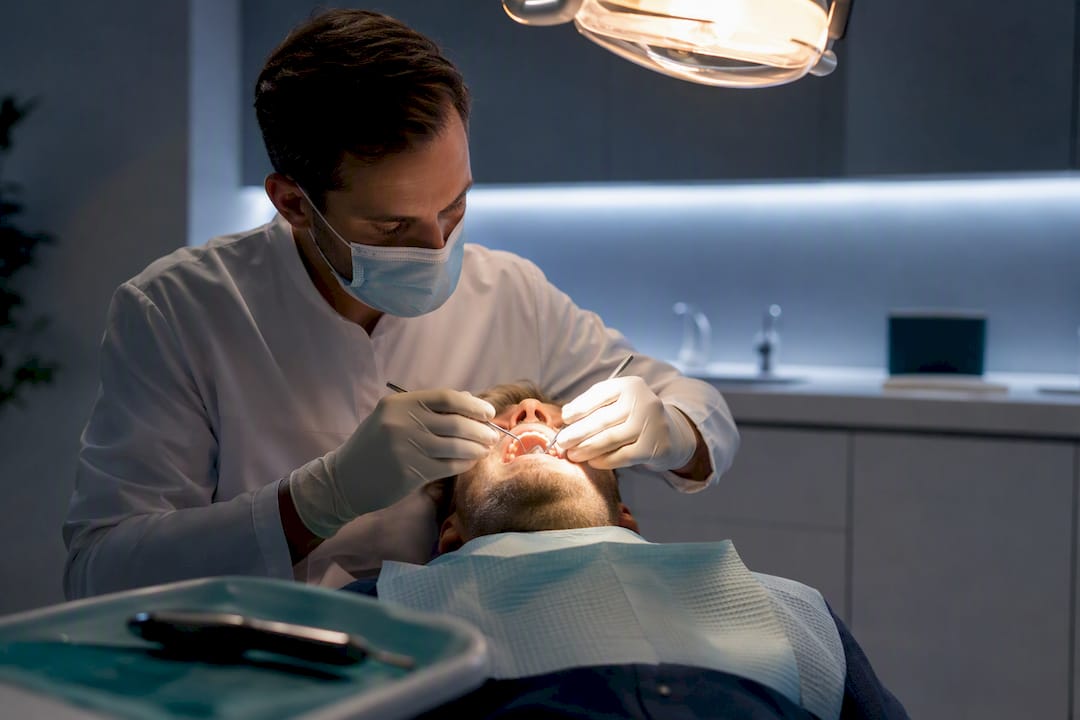 Dentist examining patient during nighttime toothache