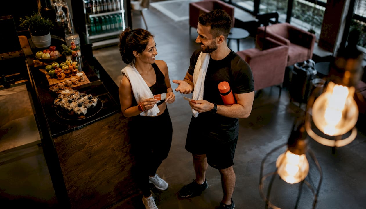Gym members exchanging referral cards in lobby