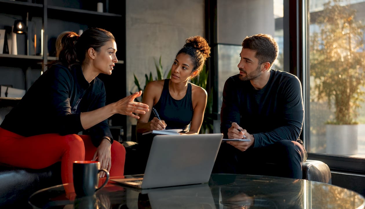 Studio staff discussing Pilates software demo