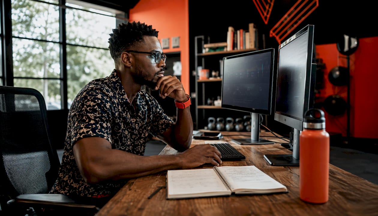 Gym manager working on fitness software at desk
