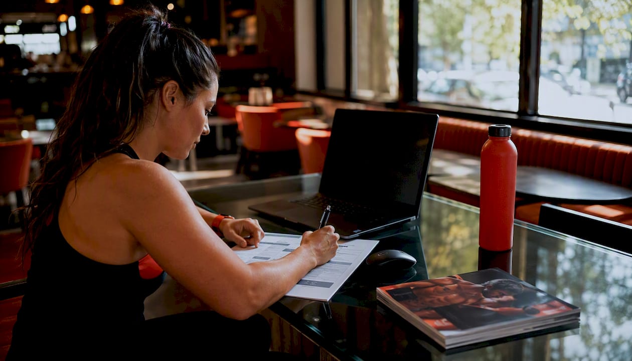 Trainer reviewing fitness software alternatives