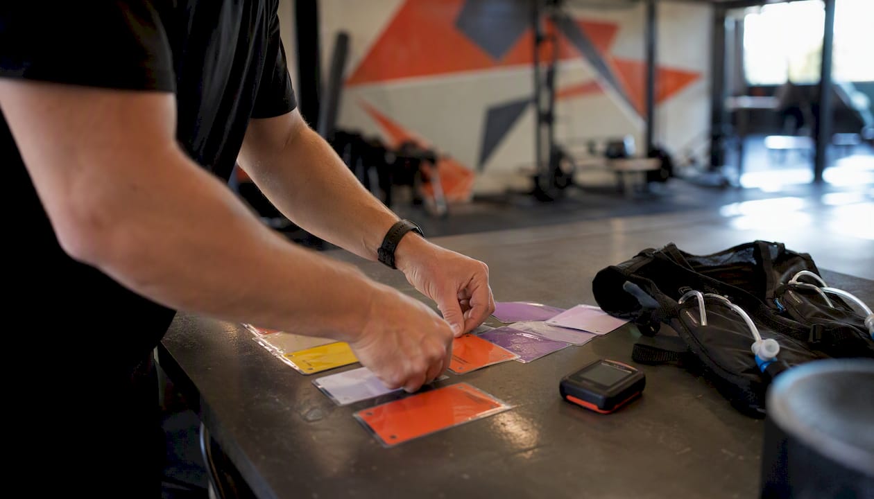 Hands organizing workout programming cards