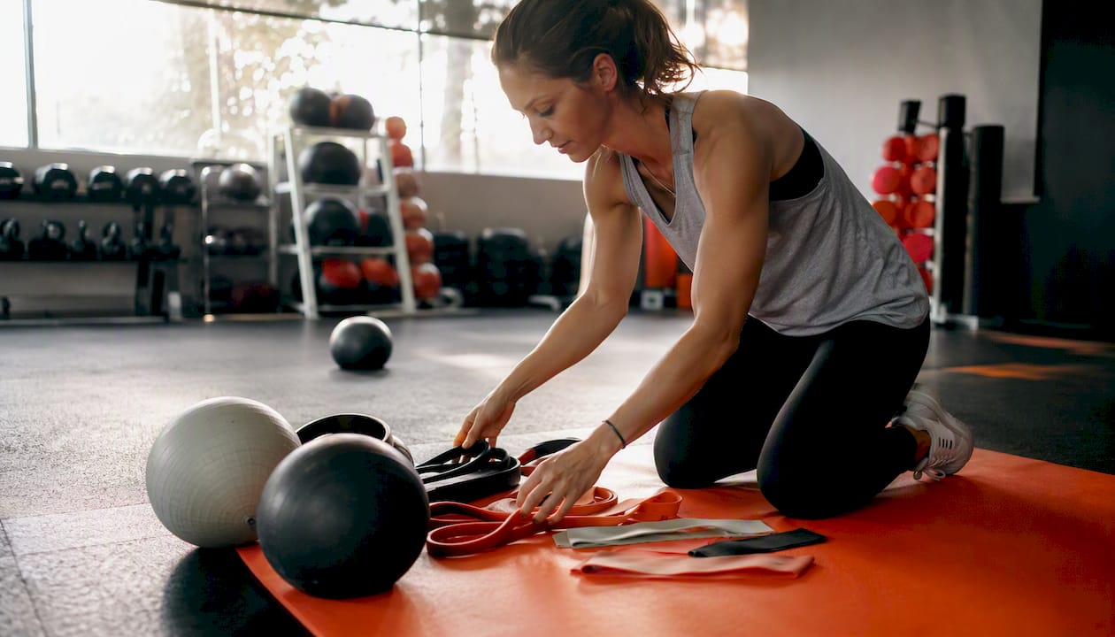 Instructor preparing group fitness class setup