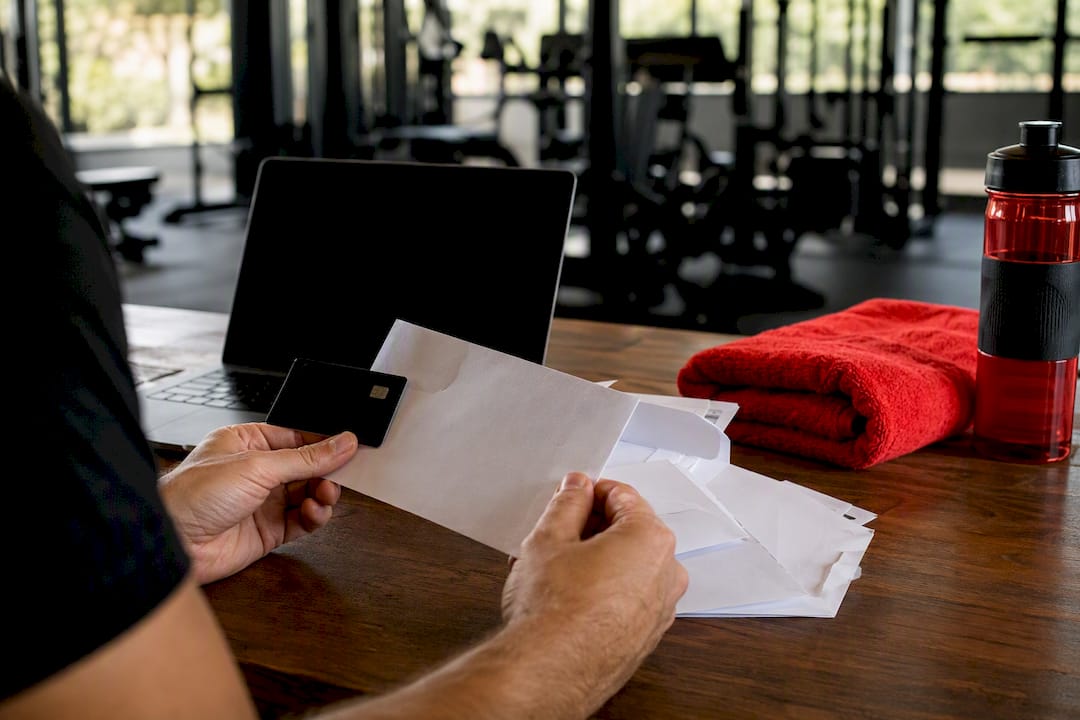 Hands handling billing notices and membership card