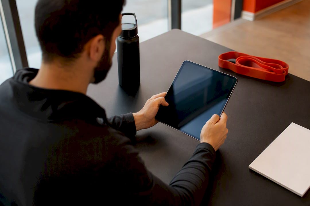 Hands taking notes on clipboard in gym office