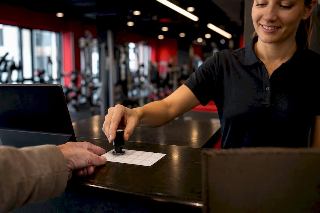 Hand stamping gym loyalty card close-up