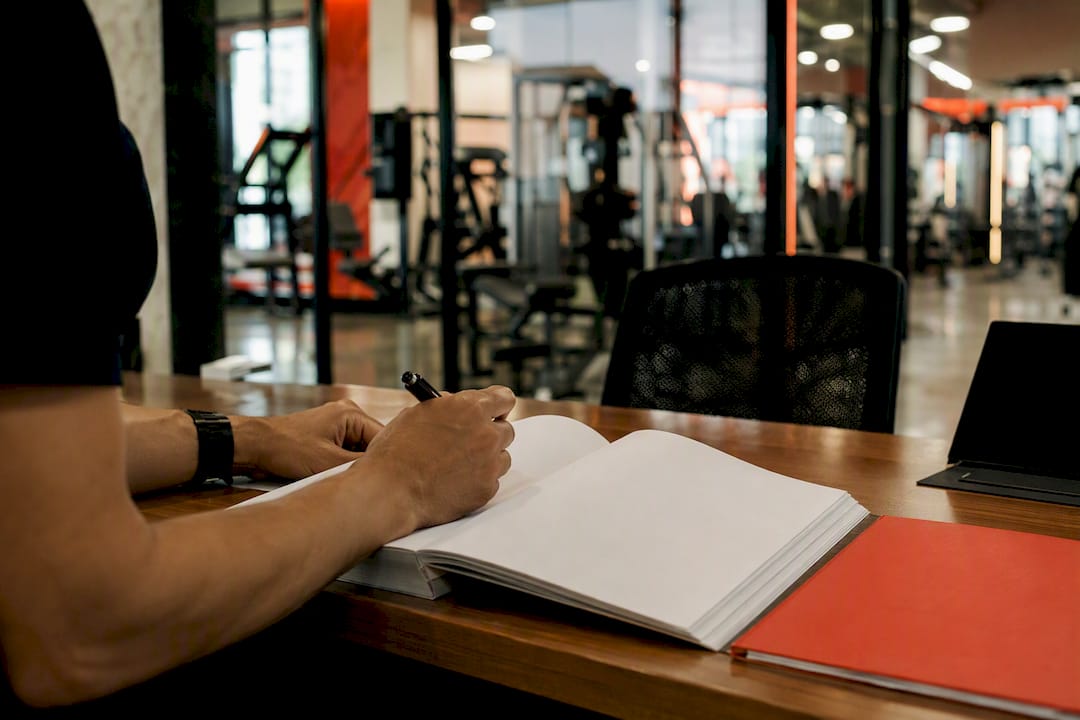 Hands reviewing gym attendance notes