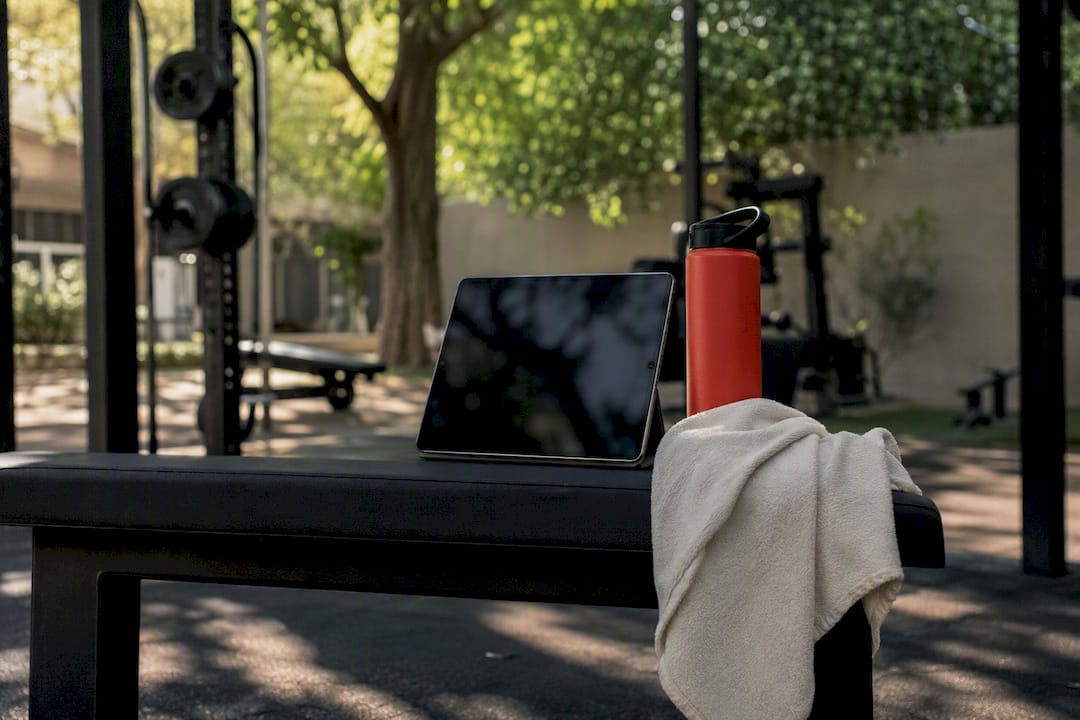 Tablet and fitness gear on gym lounge table