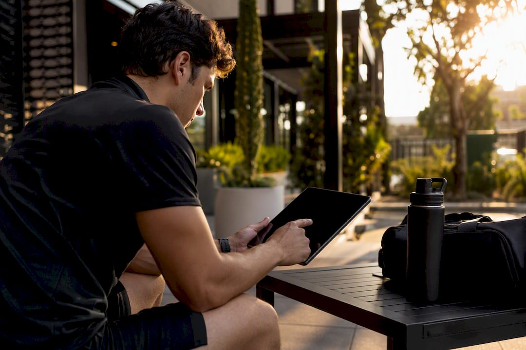 Coach updating gym member attendance on tablet
