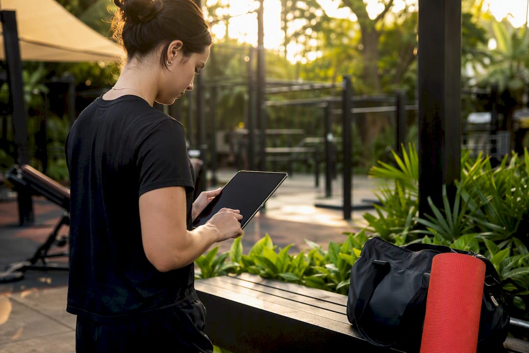 Hands holding tablet in gym reception