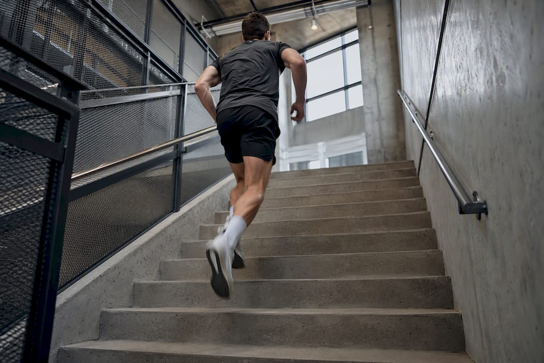 Person sprinting stairs in office stairwell