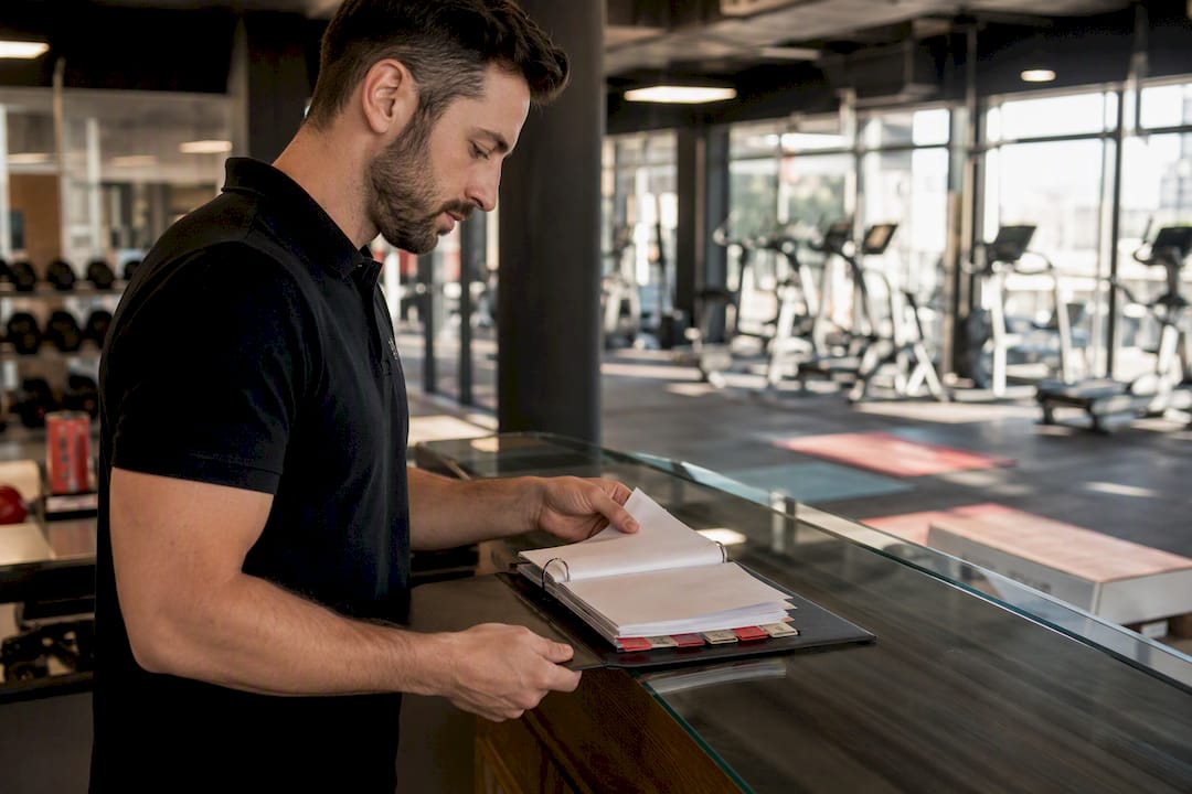 Gym manager organizing OSHA compliance binder