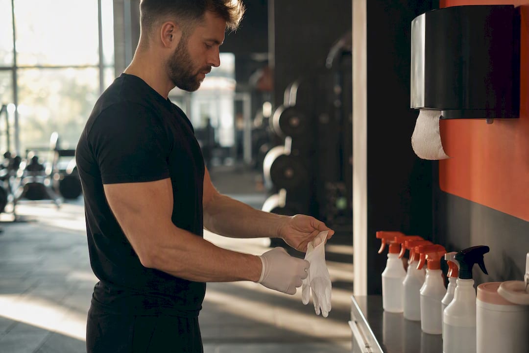 Trainer safely removing contaminated gloves