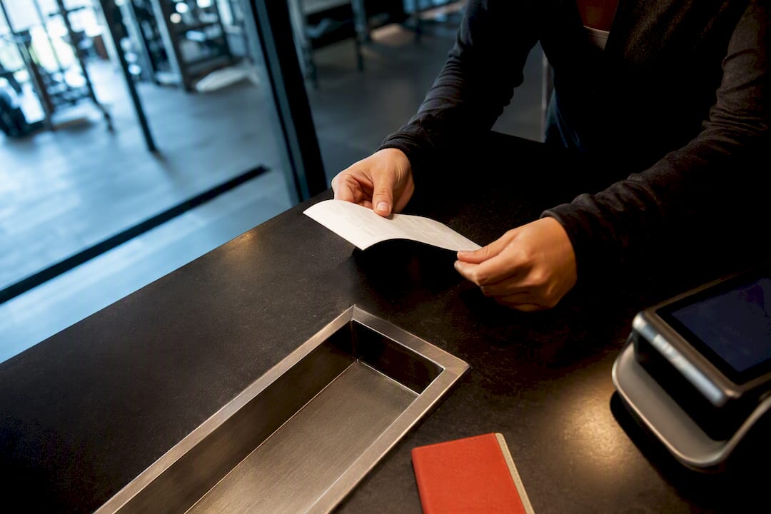 Gym staff reviewing itemized membership charge