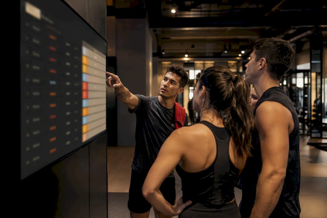 Members viewing a gym leaderboard display