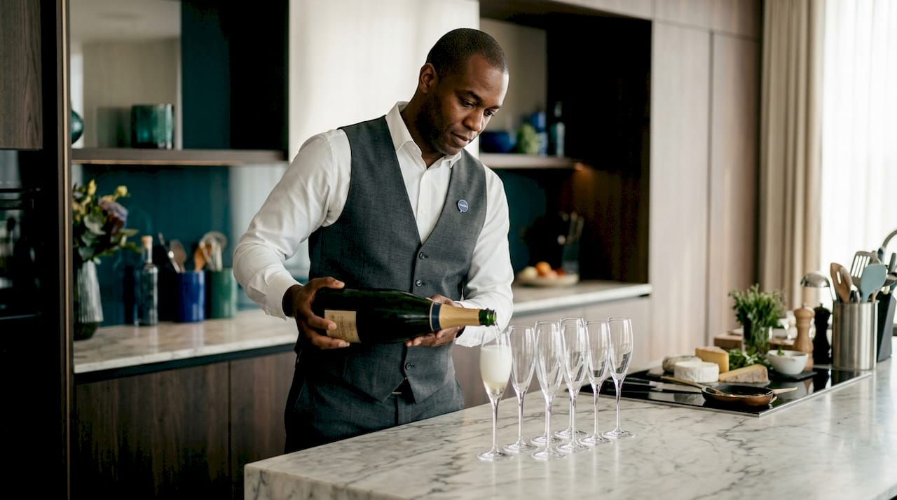 Sommelier pouring champagne at formal event