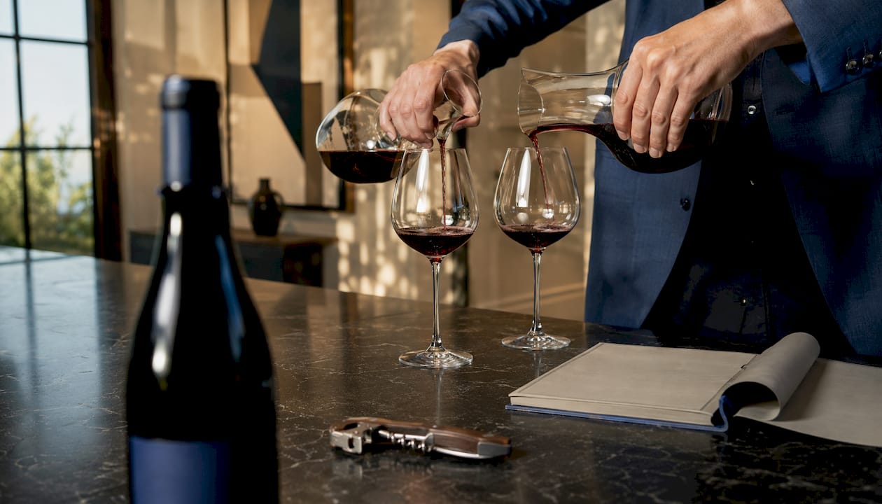 Hands pouring wines for horizontal tasting