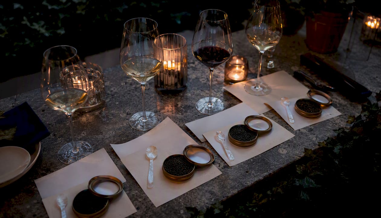 Caviar and wine tasting setup with accessories