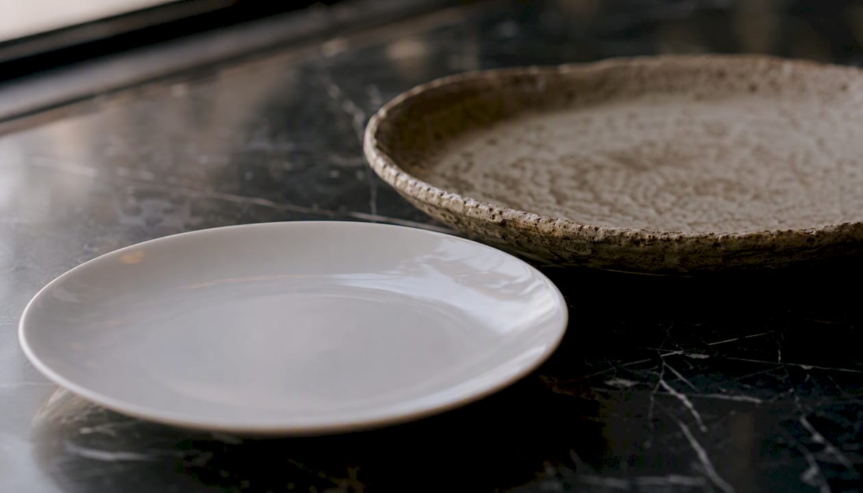 Rustic stoneware and fine porcelain plates