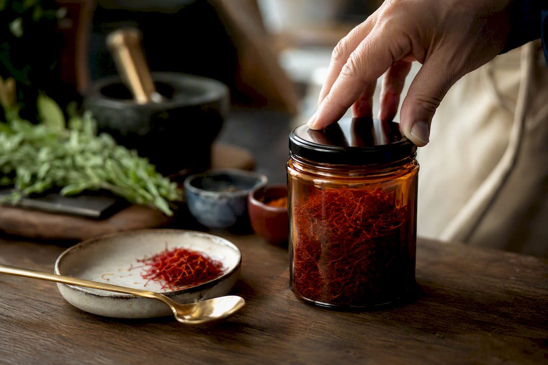 Sealing jar with saffron threads in kitchen