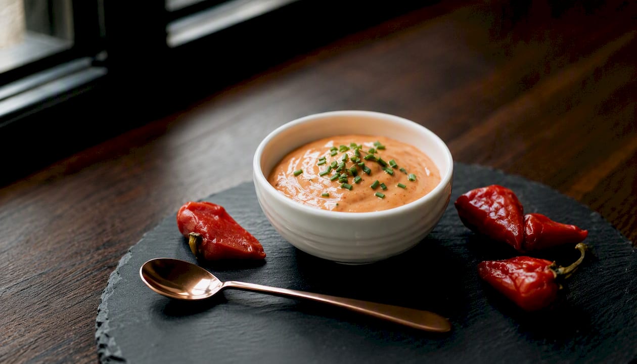 Bowl of creamy piquillo sherry-mayo sauce with parsley