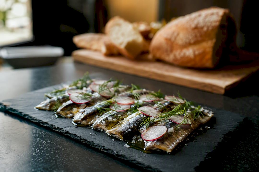 Plated sardines with fresh garnishes