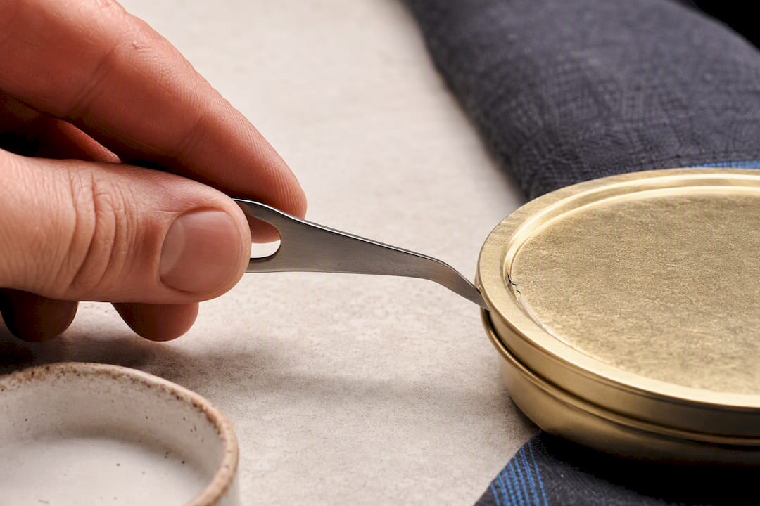 Caviar key positioned beside tin rim